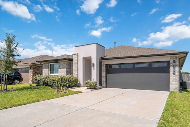 7730 Robert Ln, Rosharon, TX 77583 - view of front facade with driveway, an attached garage, a front lawn, brick siding, and stucco siding