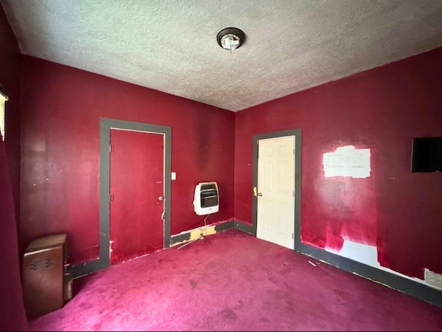 3215 Illinois St, Baytown, TX 77520 - carpeted empty room featuring heating unit and a textured ceiling