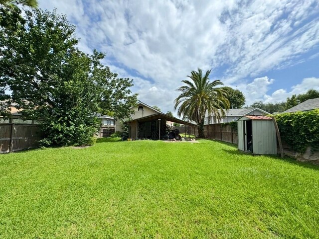3215 Illinois St, Baytown, TX 77520 - fenced backyard featuring a storage shed