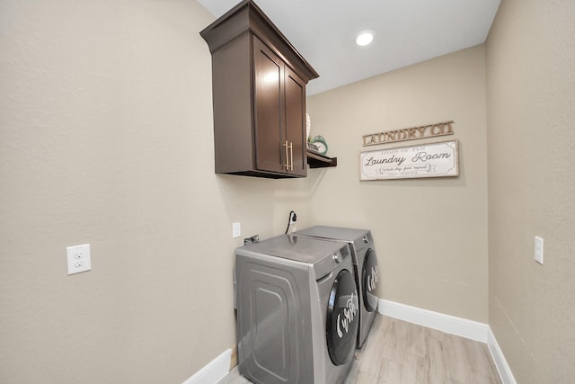 203 Pinedale Ave, Arcola, TX 77583 - laundry room featuring cabinet space, washer and clothes dryer, and light wood-style floors