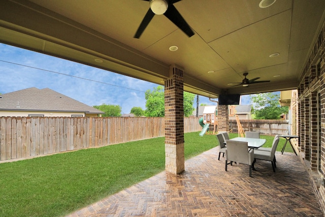 203 Pinedale Ave, Arcola, TX 77583 - fenced backyard with a playground, a ceiling fan, a patio area, and outdoor dining space