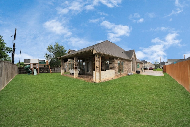 203 Pinedale Ave, Arcola, TX 77583 - rear view of property with a patio area, brick siding, a shingled roof, and a fenced backyard