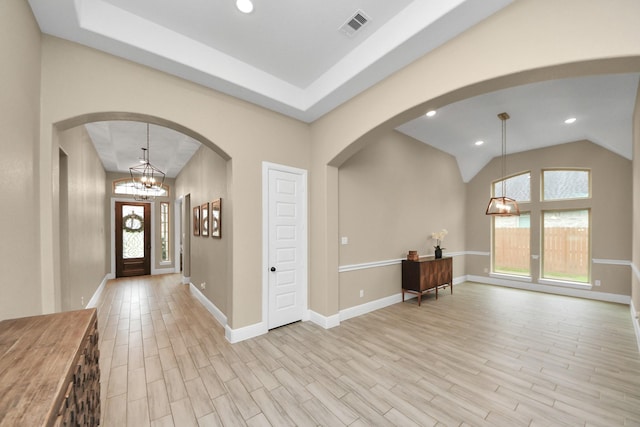 203 Pinedale Ave, Arcola, TX 77583 - entryway featuring light wood finished floors, a chandelier, lofted ceiling, arched walkways, and recessed lighting