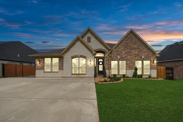 203 Pinedale Ave, Arcola, TX 77583 - french country style house featuring brick siding, a gate, stone siding, and driveway