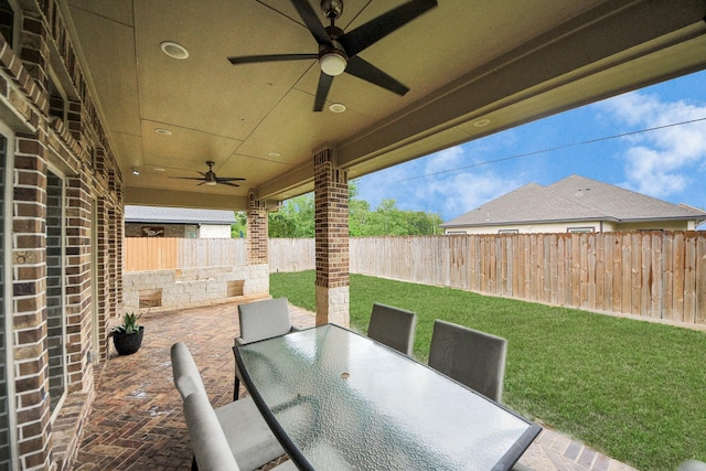203 Pinedale Ave, Arcola, TX 77583 - fenced backyard with ceiling fan, outdoor dining area, and a patio