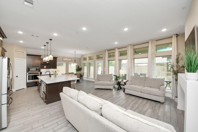 203 Pinedale Ave, Arcola, TX 77583 - living room with light wood finished floors and recessed lighting