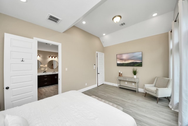 203 Pinedale Ave, Arcola, TX 77583 - bedroom featuring wood finished floors, vaulted ceiling, recessed lighting, and ensuite bathroom