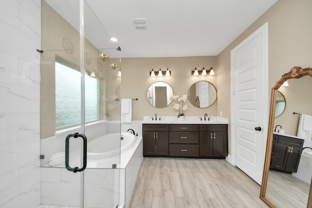 203 Pinedale Ave, Arcola, TX 77583 - bathroom featuring double vanity, a garden tub, and a stall shower