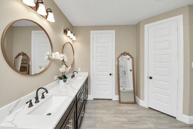 203 Pinedale Ave, Arcola, TX 77583 - bathroom featuring double vanity and wood finished floors
