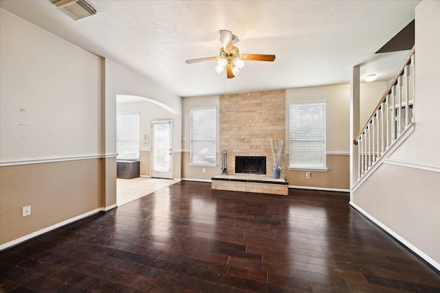 6111 Branch Lake Dr, Houston, TX 77066 - unfurnished living room featuring a ceiling fan, plenty of natural light, arched walkways, and wood-type flooring