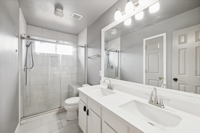 6111 Branch Lake Dr, Houston, TX 77066 - bathroom featuring a stall shower, double vanity, tile patterned floors, and a textured ceiling