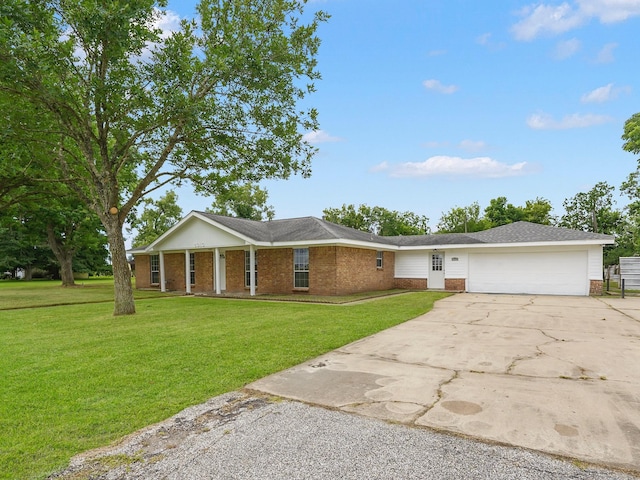 5010 Riverview Dr, Alvin, TX 77511 - view of front of home featuring brick siding, driveway, a garage, and a front yard