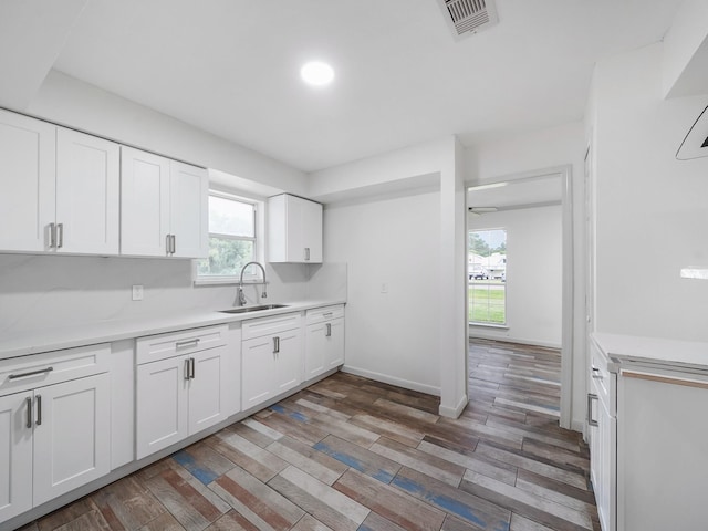 5010 Riverview Dr, Alvin, TX 77511 - kitchen featuring light countertops, white cabinetry, light wood-type flooring, and recessed lighting