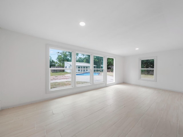 5010 Riverview Dr, Alvin, TX 77511 - empty room with recessed lighting and light wood-style flooring
