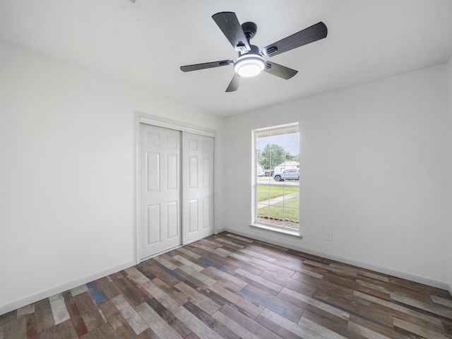 5010 Riverview Dr, Alvin, TX 77511 - unfurnished bedroom with wood finished floors, a closet, and ceiling fan