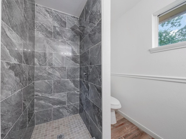 5010 Riverview Dr, Alvin, TX 77511 - bathroom with tiled shower and wood finished floors