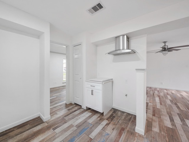 5010 Riverview Dr, Alvin, TX 77511 - kitchen featuring light wood-style flooring, white cabinets, ceiling fan, and light countertops