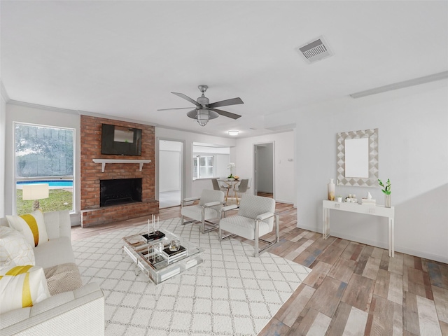 5010 Riverview Dr, Alvin, TX 77511 - living area with wood finished floors, a brick fireplace, and ceiling fan