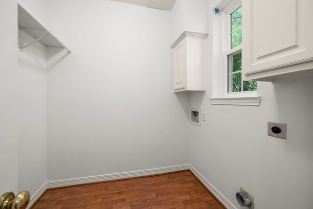 1922 Stormcroft Cir, Katy, TX 77450 - washroom with cabinet space, wood finished floors, hookup for a washing machine, and healthy amount of natural light