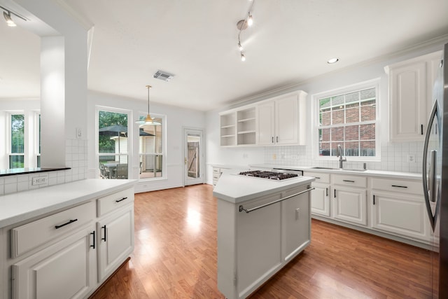 1922 Stormcroft Cir, Katy, TX 77450 - kitchen with open shelves, white cabinets, backsplash, and appliances with stainless steel finishes