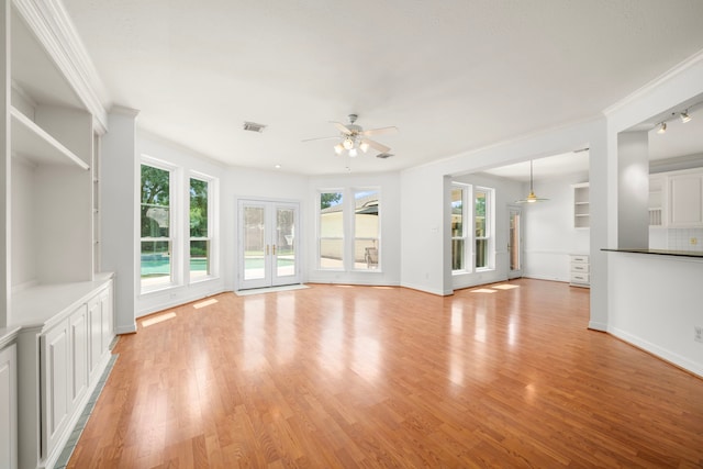 1922 Stormcroft Cir, Katy, TX 77450 - unfurnished living room with ceiling fan, healthy amount of natural light, light wood-style floors, and ornamental molding