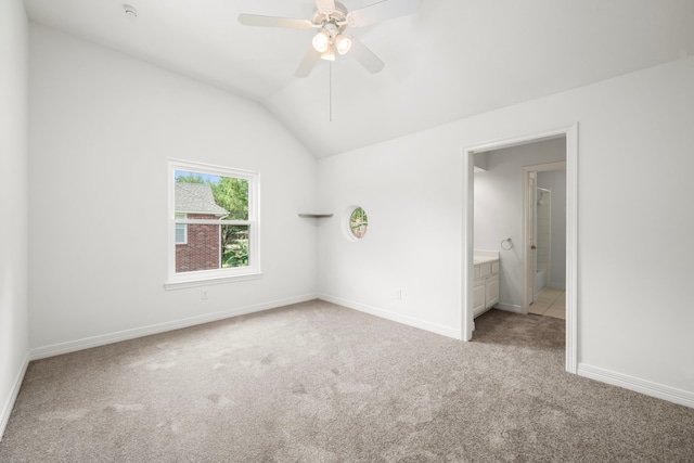 1922 Stormcroft Cir, Katy, TX 77450 - unfurnished bedroom featuring light carpet, vaulted ceiling, ceiling fan, and connected bathroom
