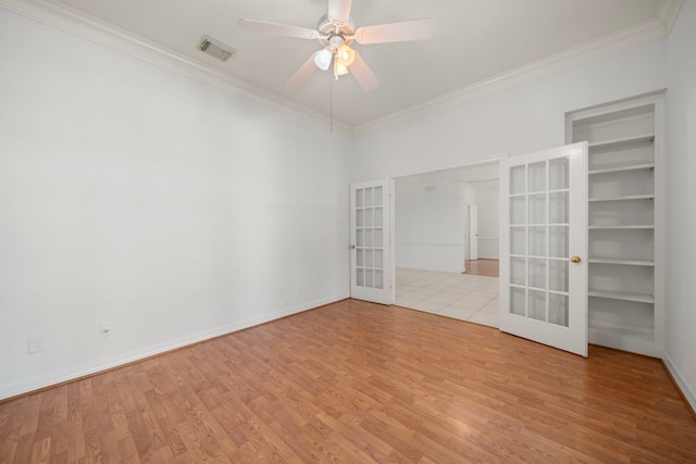 1922 Stormcroft Cir, Katy, TX 77450 - spare room featuring french doors, ornamental molding, wood finished floors, and ceiling fan
