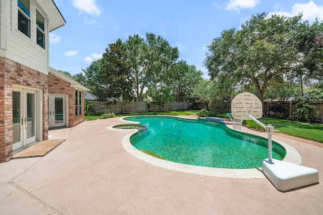 1922 Stormcroft Cir, Katy, TX 77450 - view of swimming pool with french doors, a patio, a fenced backyard, and a pool with connected hot tub