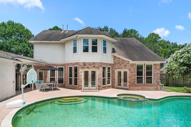 1922 Stormcroft Cir, Katy, TX 77450 - rear view of property featuring french doors, brick siding, a patio, and a pool with connected hot tub