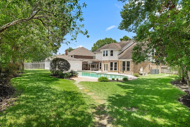 1922 Stormcroft Cir, Katy, TX 77450 - rear view of property with a fenced backyard, an outdoor pool, brick siding, and a patio