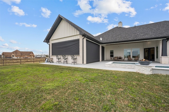 14923 Old Irish Farm Rd, Baytown, TX 77523 - back of property featuring a chimney, a patio area, and board and batten siding