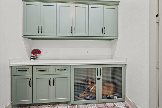 14923 Old Irish Farm Rd, Baytown, TX 77523 - kitchen with green cabinetry and light countertops