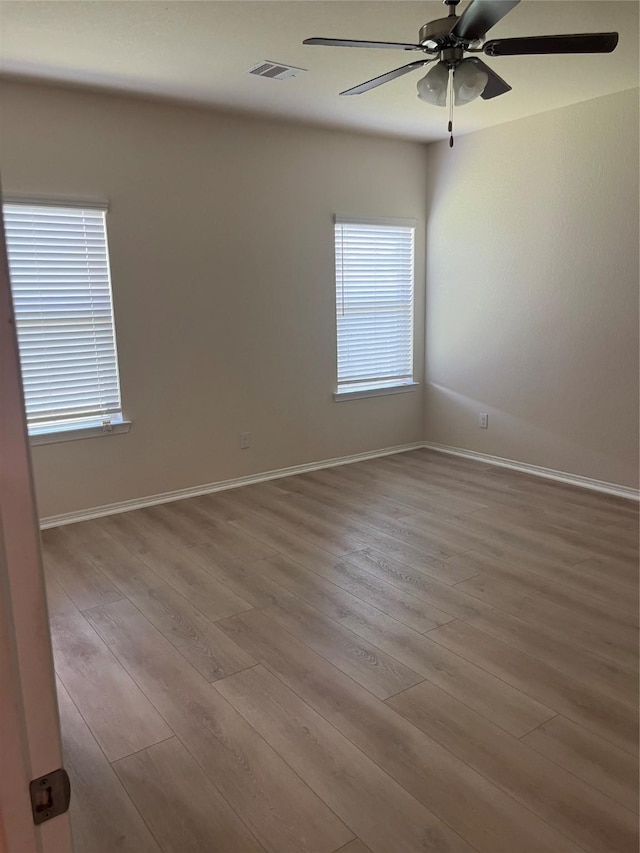 2135 Republic Way, Missouri City, TX 77489 - empty room with ceiling fan, wood finished floors, and plenty of natural light