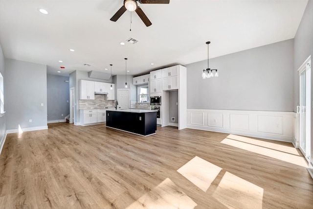 16362 Eastchase St, Montgomery, TX 77316 - unfurnished living room with ceiling fan, light wood-style flooring, recessed lighting, and a chandelier