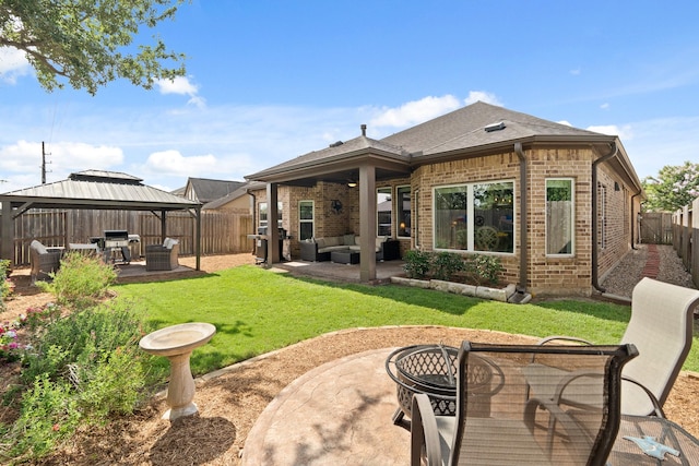 3426 Satton Ranch Ln, Fulshear, TX 77441 - rear view of house with an outdoor hangout area, brick siding, a gazebo, a patio area, and a fenced backyard