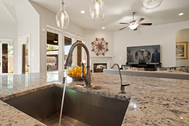 3426 Satton Ranch Ln, Fulshear, TX 77441 - kitchen featuring open floor plan, light stone counters, a ceiling fan, and recessed lighting