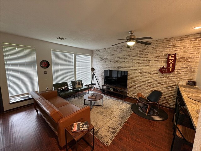 3244 Poe Dr, Montgomery, TX 77356 - living area with wood finished floors, a ceiling fan, and brick wall