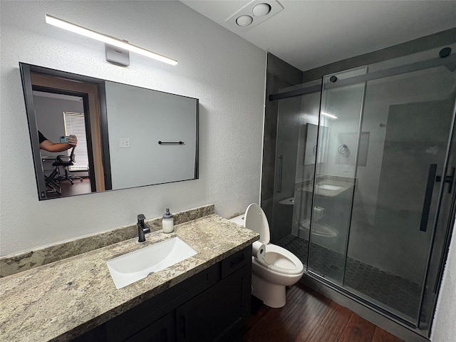 3244 Poe Dr, Montgomery, TX 77356 - bathroom with vanity, wood finished floors, a shower stall, and a textured wall