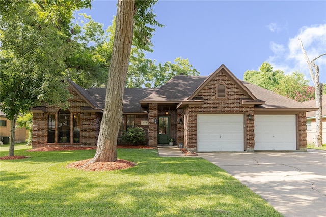214 Balsam St, Lake Jackson, TX 77566 - view of front facade with a garage, driveway, brick siding, and a front yard