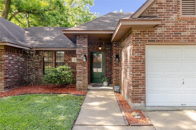 214 Balsam St, Lake Jackson, TX 77566 - view of exterior entry with a shingled roof, brick siding, and an attached garage