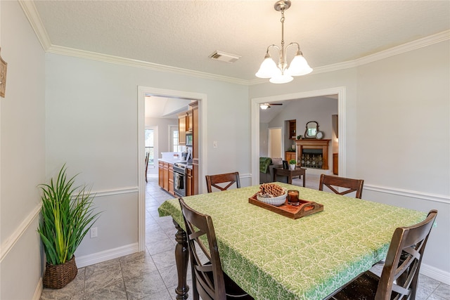 214 Balsam St, Lake Jackson, TX 77566 - dining area featuring a chandelier, ornamental molding, and a textured ceiling
