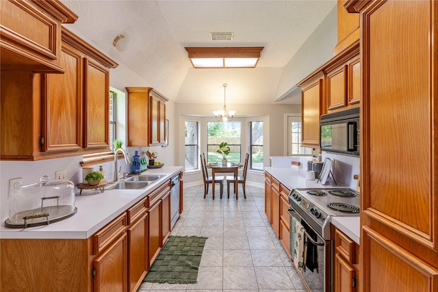 214 Balsam St, Lake Jackson, TX 77566 - kitchen featuring appliances with stainless steel finishes, light countertops, a chandelier, brown cabinetry, and vaulted ceiling