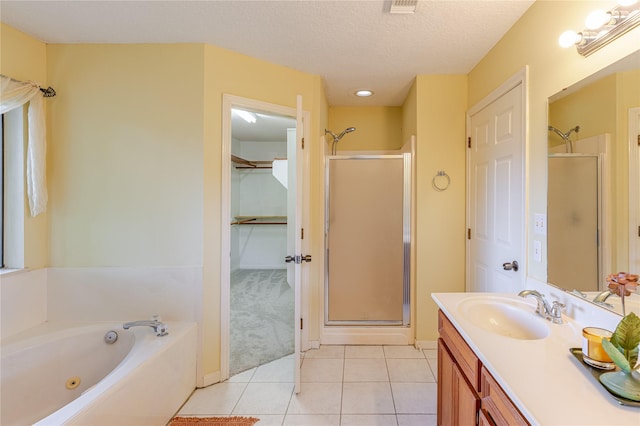 214 Balsam St, Lake Jackson, TX 77566 - bathroom featuring a stall shower, vanity, tile patterned flooring, a whirlpool tub, and a textured ceiling