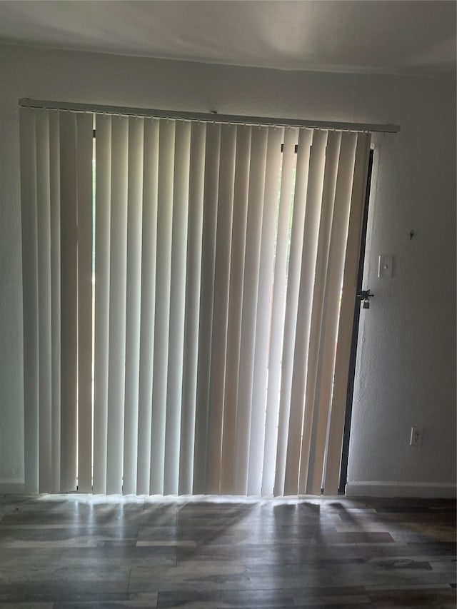 5625 Antoine Dr Unit 1011, Houston, TX 77091 - detailed view of wood finished floors, a gate, and a textured wall