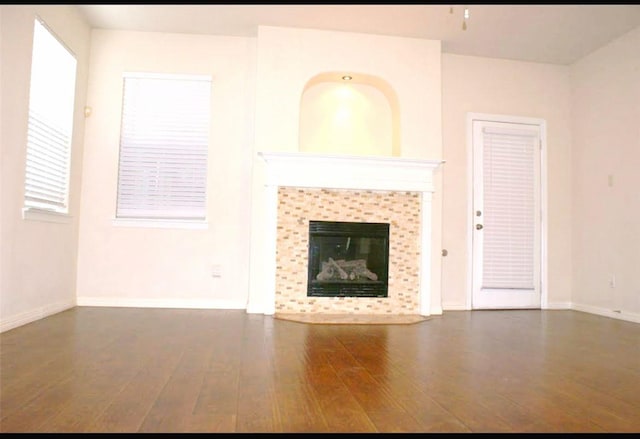 20518 Bonds Creek Ln, Spring, TX 77388 - unfurnished living room with wood finished floors and a tiled fireplace