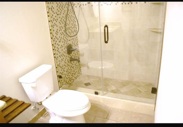20518 Bonds Creek Ln, Spring, TX 77388 - bathroom featuring a shower stall and tile patterned flooring