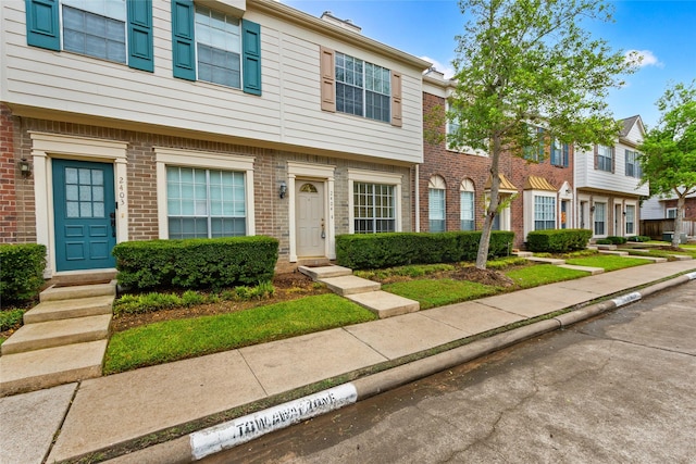 2930 Grants Lake Blvd Unit 2404, Sugar Land, TX 77479 - colonial home featuring brick siding and a residential view