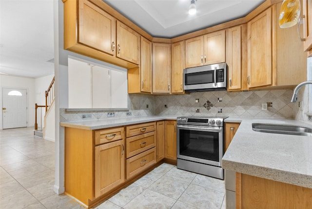 2930 Grants Lake Blvd Unit 2404, Sugar Land, TX 77479 - kitchen featuring appliances with stainless steel finishes, light tile patterned floors, backsplash, and light stone countertops