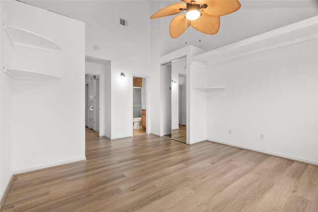 2930 Grants Lake Blvd Unit 2404, Sugar Land, TX 77479 - unfurnished bedroom featuring a towering ceiling, wood finished floors, and connected bathroom