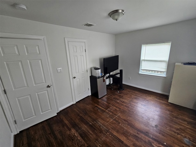 907 Whitaker Ave, Pasadena, TX 77506 - unfurnished office with dark wood finished floors and baseboards
